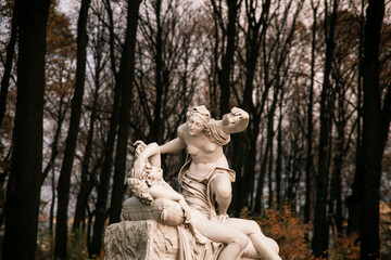 a white sculpture in the park. A man and a woman. Greek mythology. marble sculpture