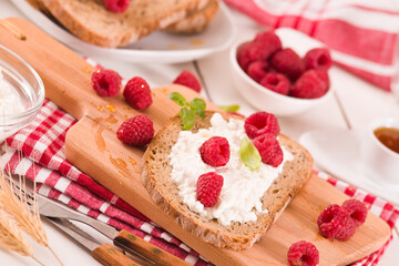 Rye bread with cottage cheese and raspberries.