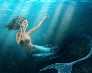 Siren of the sea. Shot of a mermaid swimming in solitude in the deep blue sea - ALL design on this image is created from scratch by Yuri Arcurs team of professionals for this particular photo shoot.