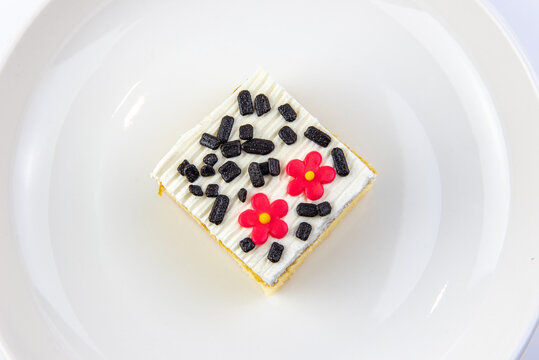 Square cake on white plate