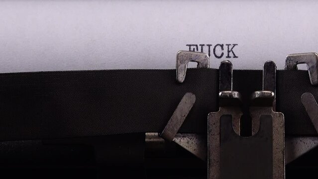 Typing phrase "FUCK PUTIN" on retro typewriter.