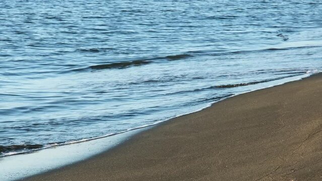 Black Sea coastline in Georgia Ureki, dark magnette balneotherapy sand and blue sea water waves, sunset beach coastline
