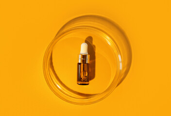 Amber bottle. Laboratory glass petri dish with pipette of water, serum, oil, beauty product....