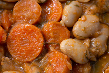 Baked giant beans with parsley,  chopped carrots and tomato sauce. Greek traditional food. selective focus