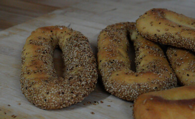 Homemade Jerusalem Sourdough, several bagels placed on a wooden plank.