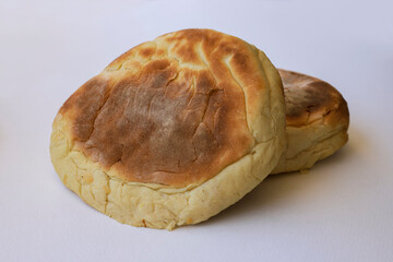 Two pita flat bread isolated on white background .