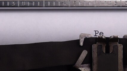 Typing phrase "Peace in Ukraine" on retro typewriter.