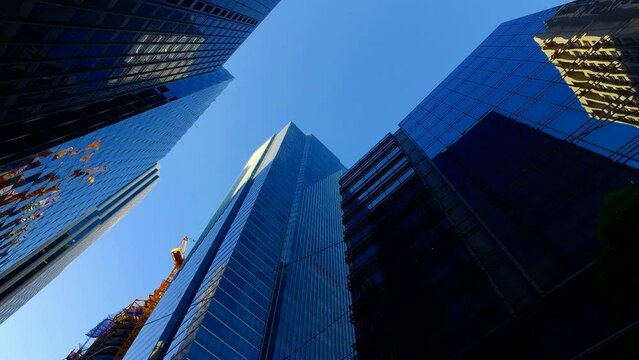 We pass through the buildings, Business world, tall buildings, a crowded city. 4K