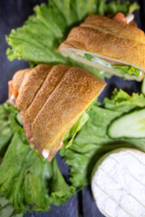delicious croissants with salmon and fresh salad on a wooden background. A delicious snack.