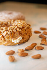 A piece of delicious handmade donut with nuts close-up