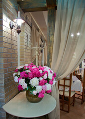 Interior in Provence style with elegant furniture and a bouquet of peonies.