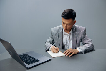 manager writing in a notebook laptop work at the desktop executive