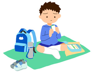 お弁当を食べている男の子