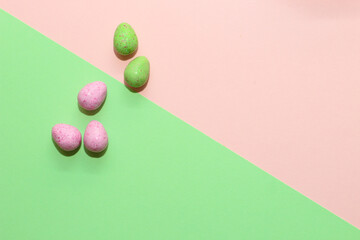 Multi-colored Easter decorative eggs on a pastel background.