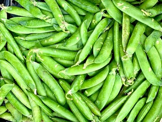 Fresh organic green beans (green peas) on a street market in London. England.