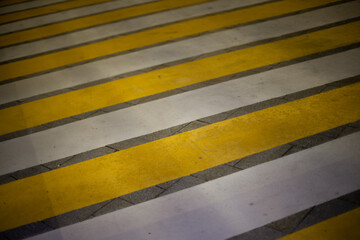 Pedestrian crossing markings on the road - white and yellow stripes to cross road and attract attention to pedestrians, safety on roads