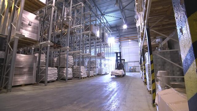 Hand pallet truck, or pallet jack with cargo pallet shipment in blur warehouse. Forklift loader
