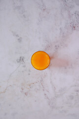  Still Life an orange juice in a white stone background
