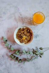 Still life. healthy breakfast. cereals and orange juice in a white stone background