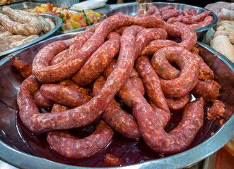 Fototapeta premium Full strip of fresh raw sausage at the butcher shop