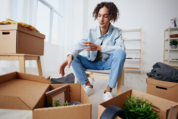 portrait of a man unpacking things from boxes in the room Lifestyle