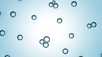 Small transparent bubbles of hyaluronic acid floating spontaneously in transparent liquid against blue background | Abstract cosmetic ingredients background