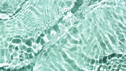 Fototapeta premium Water waves and ripples crossing against green mint background | product background, skin hydration concept