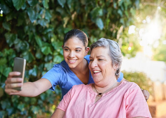 Naklejka premium Lets see your biggest smile for the selfie. Cropped shot of a caregiver taking a selfie with a senior patient outside.