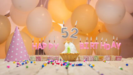 Beautiful background happy birthday number 52 with burning candles, birthday candles pink letters...