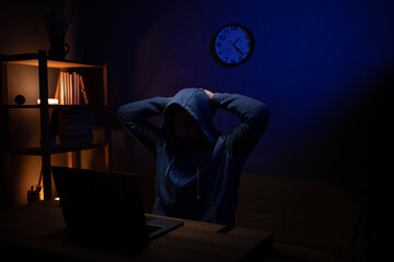 Hacker man working laptop computer. Hacker attack in dark room background