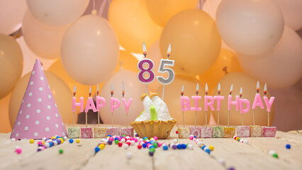Beautiful background happy birthday number 85 with burning candles, birthday candles pink letters for eight ten five years. Festive background with balloons
