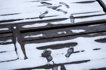 Pontoon covered with melted snow and footprints.