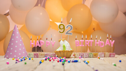 Beautiful background happy birthday number 92 with burning candles, birthday candles pink letters for ninety two years. Festive background with balloons