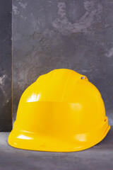 Construction helmet on cement  background. Hardhat tool