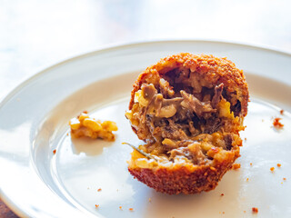 Close up shot of deep fried oxtail ball with Risotto