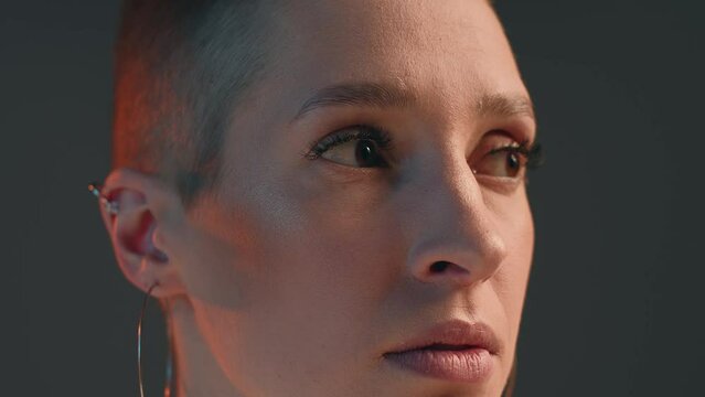 Beautiful short haired young girl blinking by long lashes with mascara, modern makeup, stare aside, closeup. ProRes