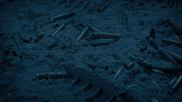 Bullets And Boot Prints On Sandy Beach In The Evening
