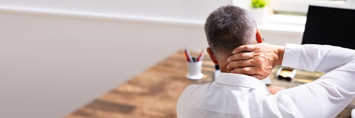 Businessman Suffering From Neck Pain