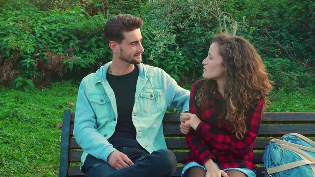 disturbing element - couple at park is about to kiss when a pushy friend arrives