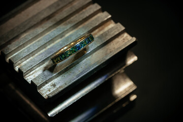 Craft jewelery making with professional tools. Ring repairing. Putting the diamond on the ring. Macro shot. A handmade jeweler process, manufacture of jewelery.