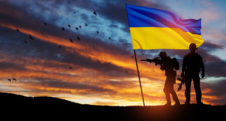 Flag of Ukraine with silhouette of soldier against the sunrise or sunset. Concept - armed forces of...