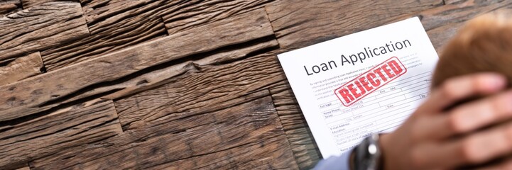 Person Looking At Rejected Loan Application