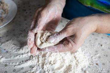  Woman cooking pies with meat at home. Cooking and baking at home.