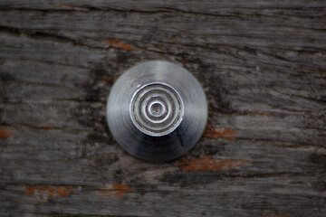 Circular rivets in wood deck.