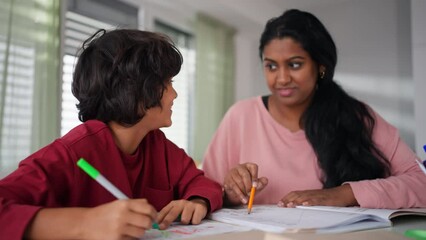Little multiracial boy doing homework with his mother at home. - Powered by Adobe