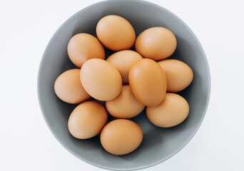 White eggs on a grey plate and a white background