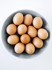 White eggs on a grey plate and a white background