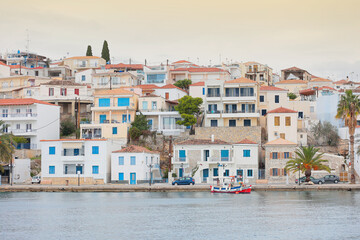 view of the pier and houses from the sea in greece.
