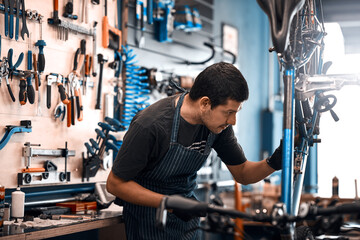 Bicycles are his business. Shot of a man working in a bicycle repair shop.