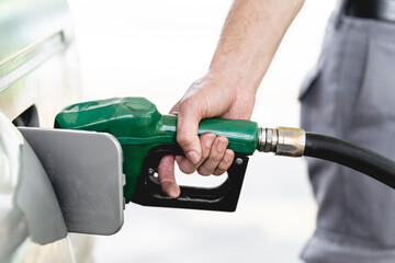 Close-up of the hand of an unknown person fueling an automobile